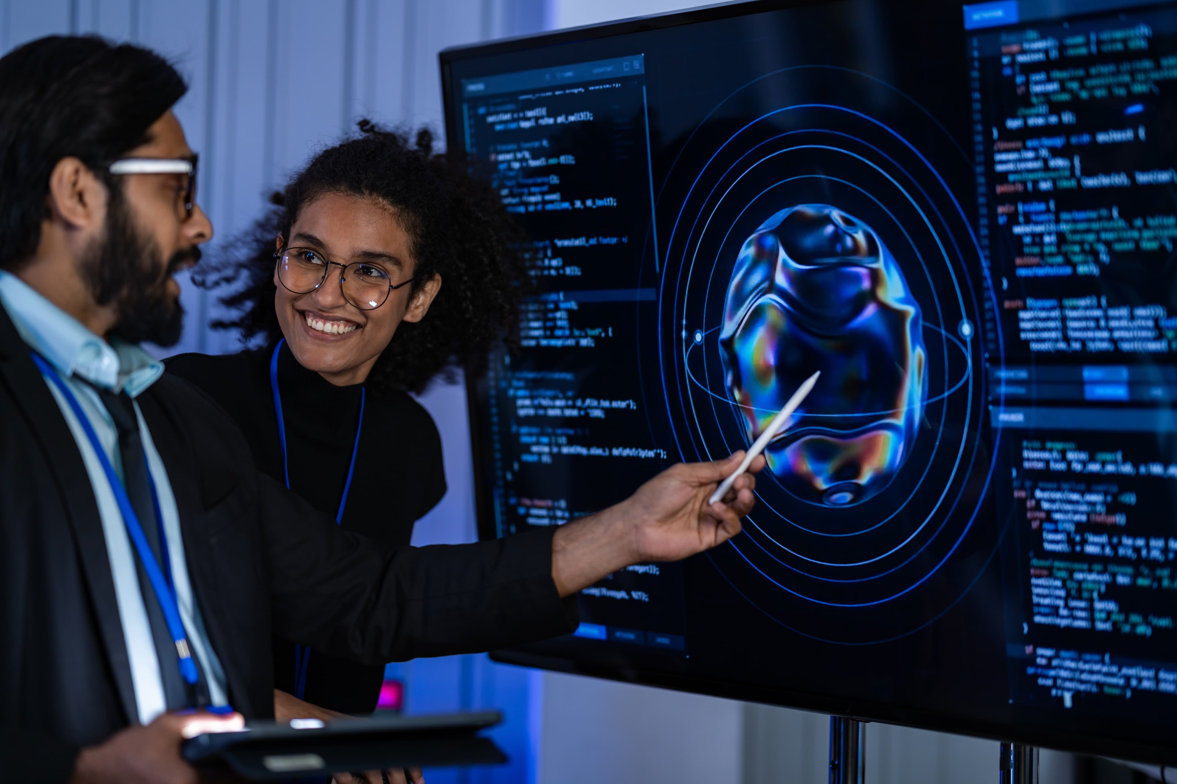 Two people discussing AI-generated visuals on screen